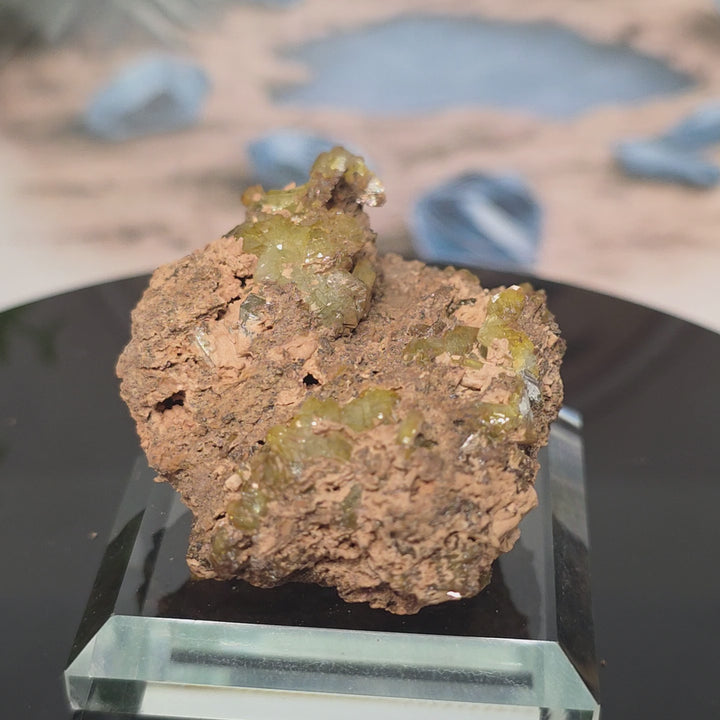 Vibrant Adamite Specimen from Ojuéla Mine exhibiting glowing green crystal formations.