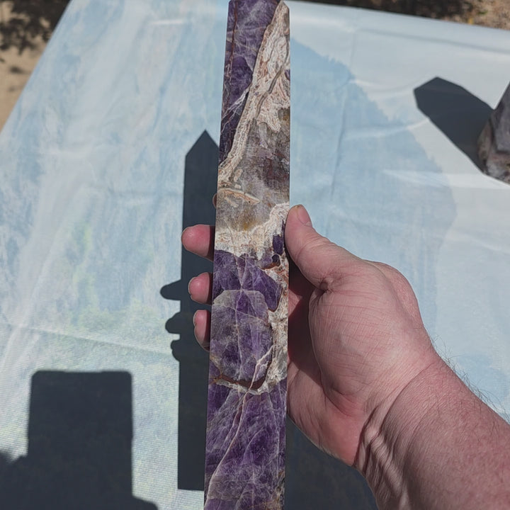 Beautiful chevron amethyst tower with deep purple colors, excellent point, and steady base. Picture taken on sunlight to show the beautiful colors. Over a foot tall with beaitiful polish Chevron amethyst, also known as banded amethyst or dream amethyst, i