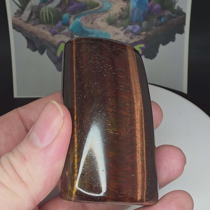 Polished Red Tiger's Eye freeform showcasing reddish-brown hues and natural stone textures.