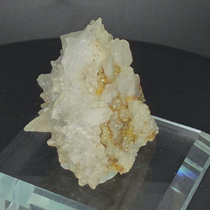 Calcite specimen from Guerrero, Mexico with glass display stand, showcasing unique crystalline structure.