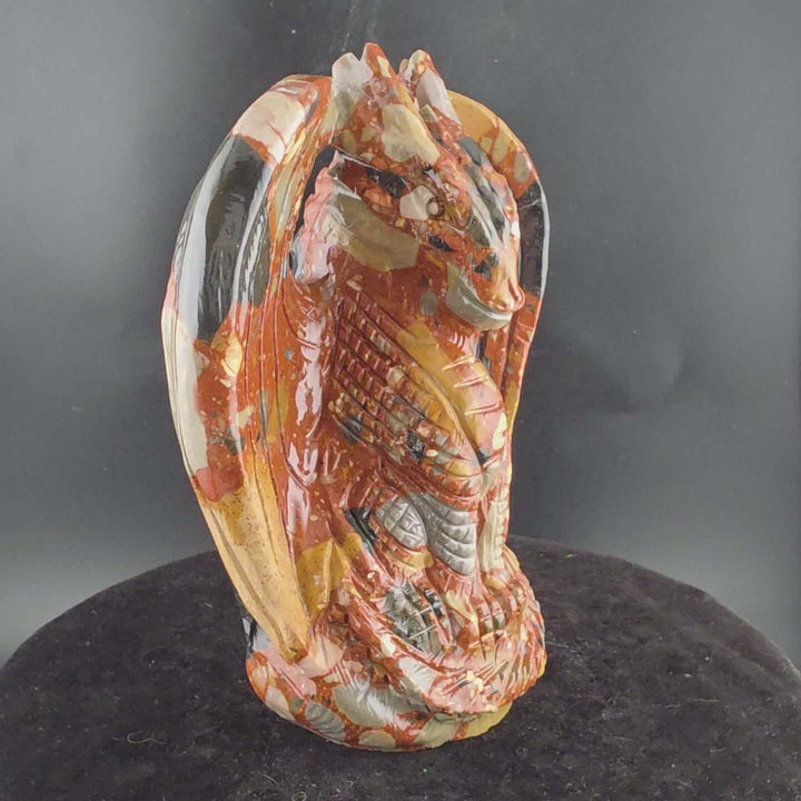 Jasper Sitting Dragon Carving, detailed sculpture in warm reds and blacks, over six inches tall.