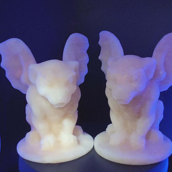 Yellow calcite gargoyle carving with wings relaxed, showcasing warm buttery yellow to honey-orange color and UV reactive