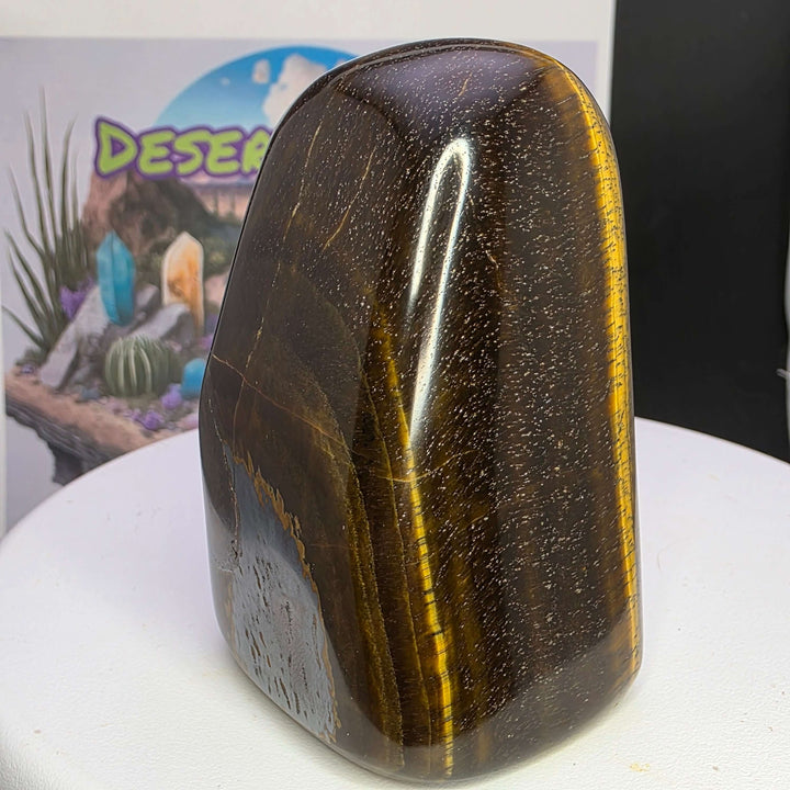 Polished Tiger's Eye freeform sculpture with stunning golden chatoyancy, showcasing smooth surface and shimmering bands.