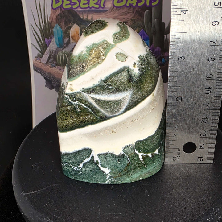 Polished Green Zebra Jasper freeform stone with green, gray, and white patterns, displayed next to a ruler for size reference.