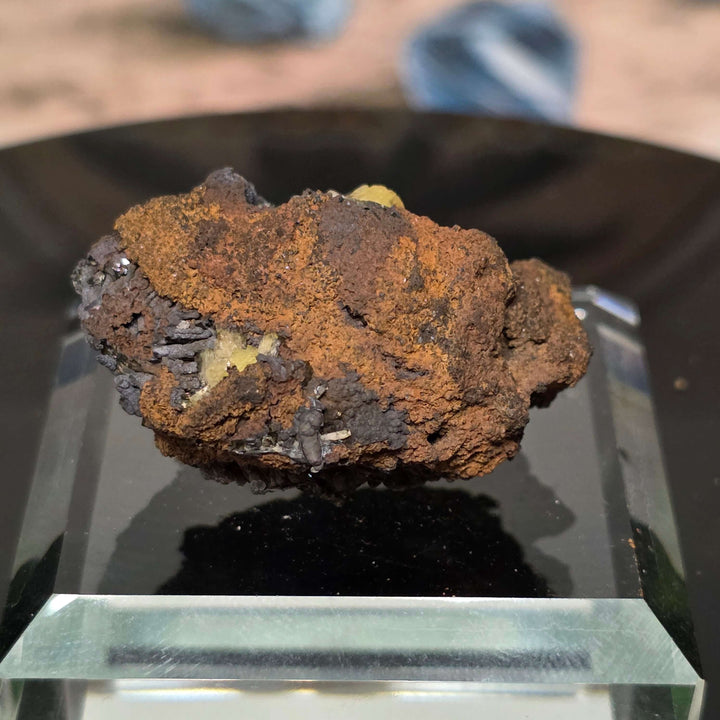 Adamite Specimen: Ojuéla Mine Collector’s Crystal displayed on a clear pedestal showcasing rich colors and unique texture.