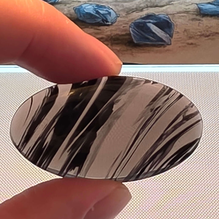 Unveil the captivating depths of our Midnight Lace Obsidian Cabochons These exquisitely polished cabochons feature the distinctive subtle banding and intricate patterns unique to Midnight Lace Obsidian, reminiscent of a moonlit night sky. Each pair is ele