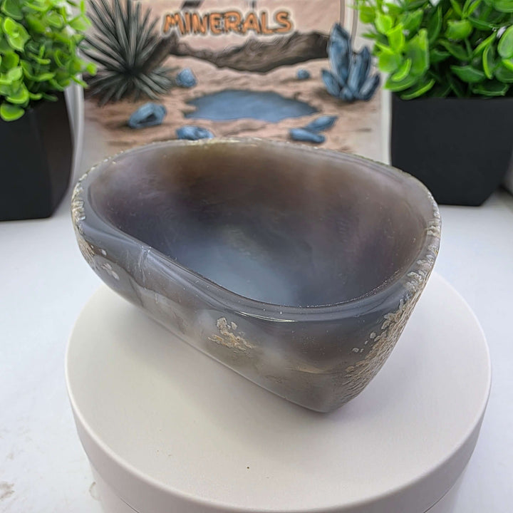 Hand carved Agate Bowl showcasing a smooth interior and rugged exterior, perfect for functional art display.