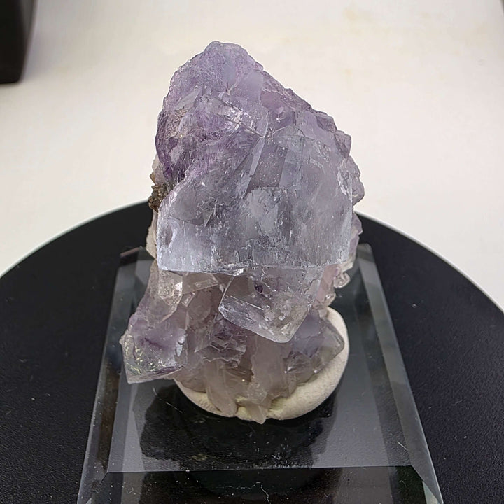 Fluorite Specimen - Yaogangxian Mine China featuring intergrown violet crystals on a display base.