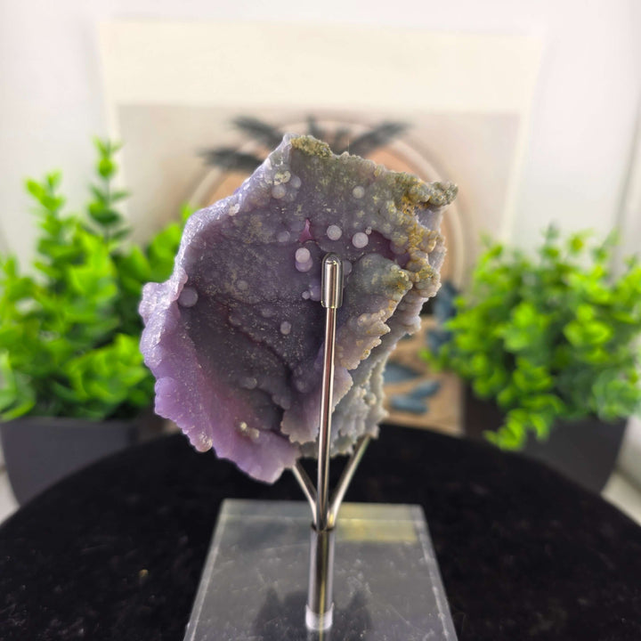 Discover the unique beauty of ‘Grape Agate’, an Amethystine Spherical Quartz found in Indonesia. This gemstone is known for its grape-like clusters and vibrant colors. Stand is included with purchase