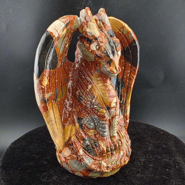 Jasper Sitting Dragon Carving, detailed sculpture in warm reds and blacks, over six inches tall.