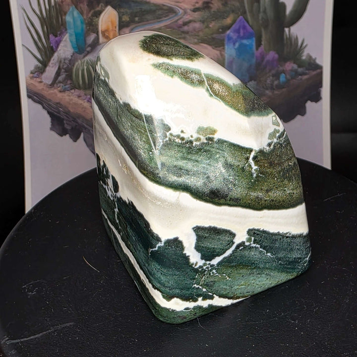 Polished Green Zebra Jasper freeform stone showcasing natural green, gray, and white patterns in a smooth finish.