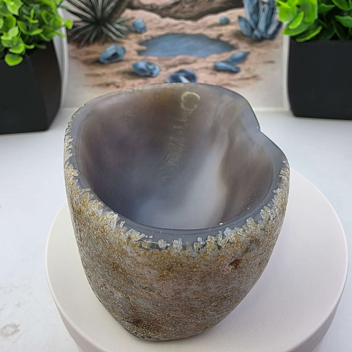 Hand carved Agate Bowl showcasing a smooth interior and rugged exterior, perfect for functional art display.