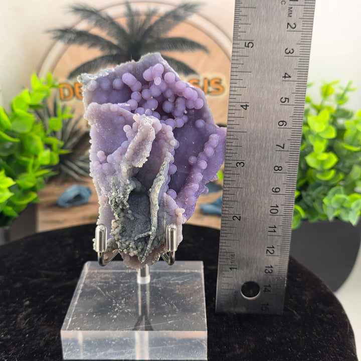 Discover the unique beauty of ‘Grape Agate’, an Amethystine Spherical Quartz found in Indonesia. This gemstone is known for its grape-like clusters and vibrant colors. Stand is included with purchase