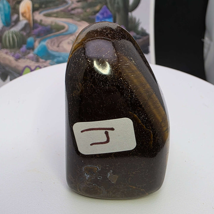 Polished Tiger's Eye freeform sculpture showcasing stunning golden chatoyancy against a simple background.
