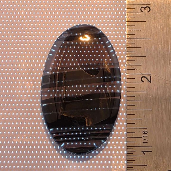 Unveil the captivating depths of our Midnight Lace Obsidian Cabochons These exquisitely polished cabochons feature the distinctive subtle banding and intricate patterns unique to Midnight Lace Obsidian, reminiscent of a moonlit night sky. Each pair is ele