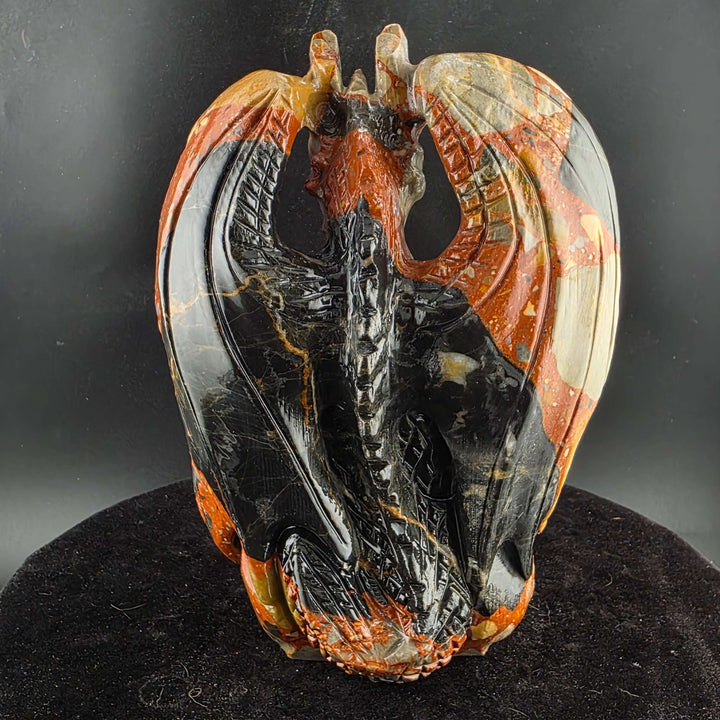 Jasper Sitting Dragon Carving, detailed sculpture in warm reds and blacks, over six inches tall.