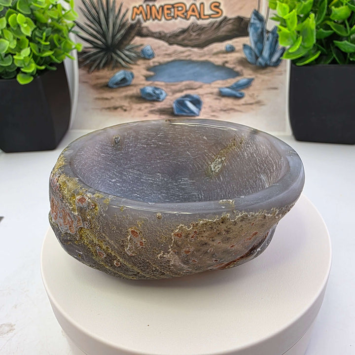 Hand carved Agate Bowl showcasing a smooth interior and rugged exterior, perfect for functional art display.