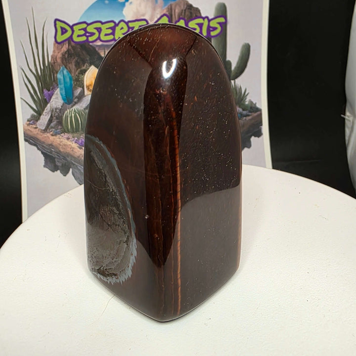 Polished Red Tiger's Eye freeform sculpture showcasing reddish-brown hues, ideal for home decor or crystal collection.