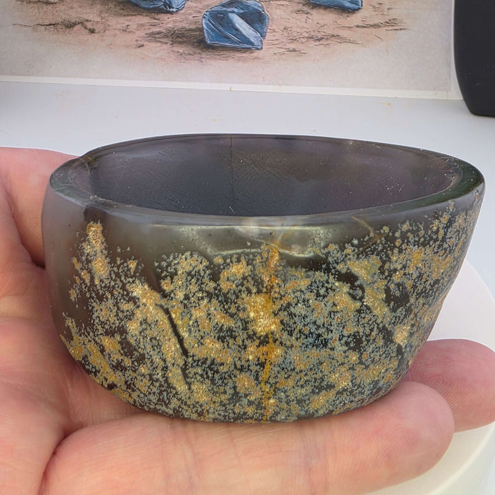 Hand carved Agate Bowl showcasing a smooth interior and rugged exterior, perfect for functional art display.