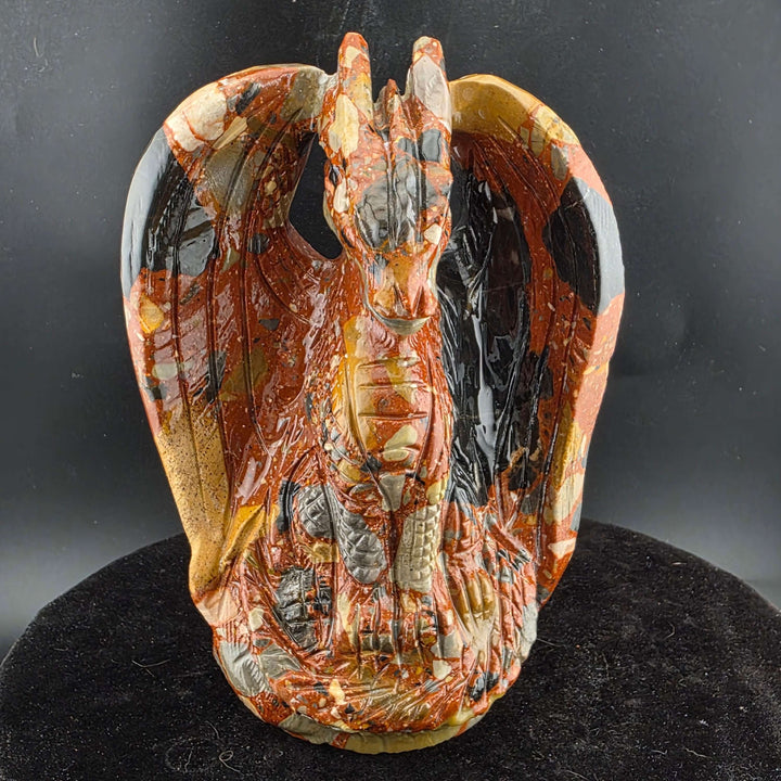 Jasper Sitting Dragon Carving, detailed sculpture in warm reds and blacks, over six inches tall.