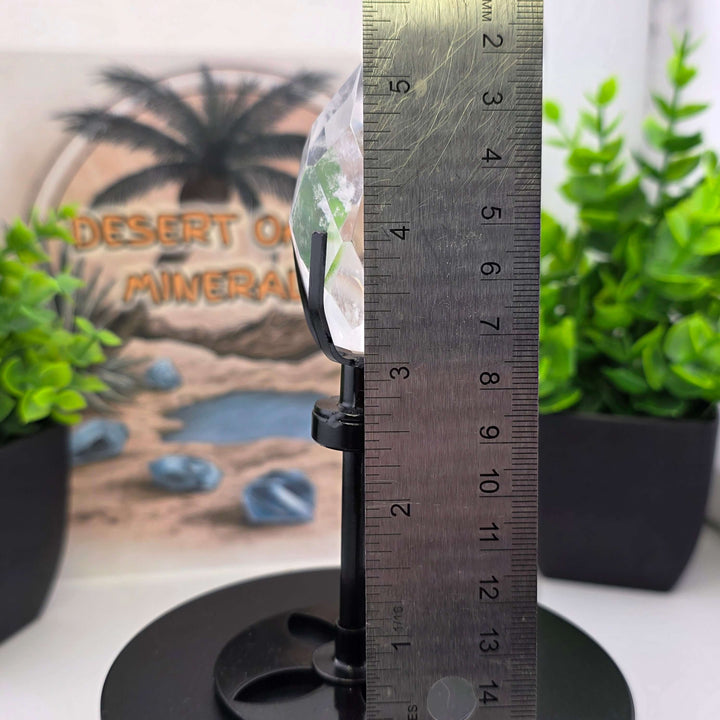 Polished Faceted Clear Quartz Crystal Tear Drop with Stand alongside a ruler for size reference.