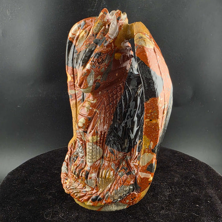 Jasper Sitting Dragon Carving, detailed sculpture in warm reds and blacks, over six inches tall.