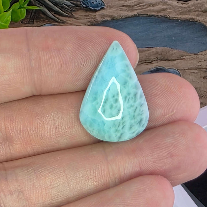 Dive into the tranquil beauty of our Larimar Cabochons. Sourced from the Dominican Republic, these rare and captivating gemstones showcase stunning shades of oceanic blues and whites, reminiscent of Caribbean waters. Each beautifully polished cabochon pai