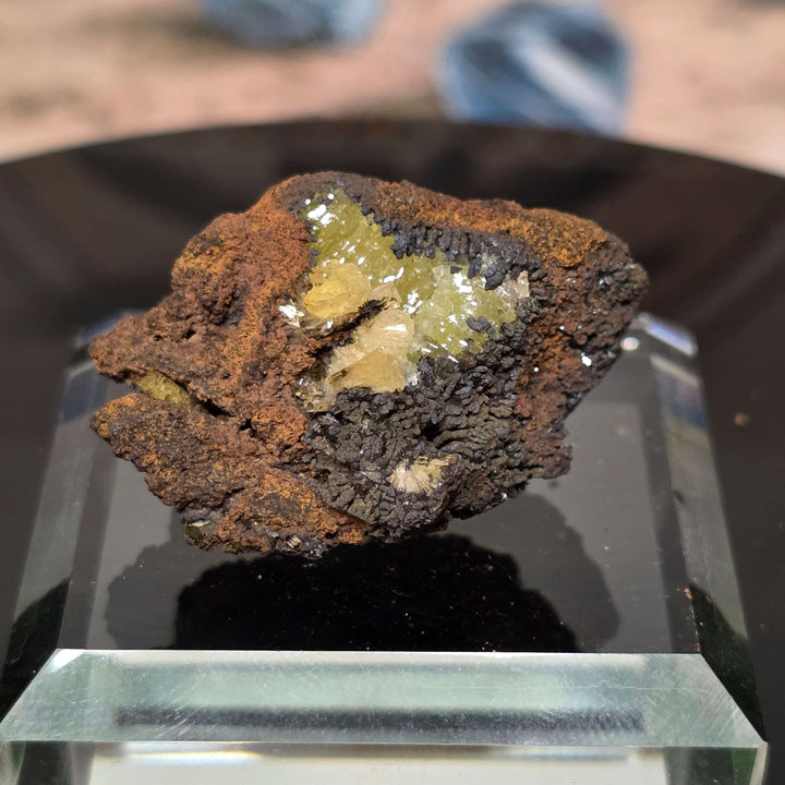 Adamite Specimen from Ojuéla Mine displayed on a crystal stand, showcasing its unique mineral formation.