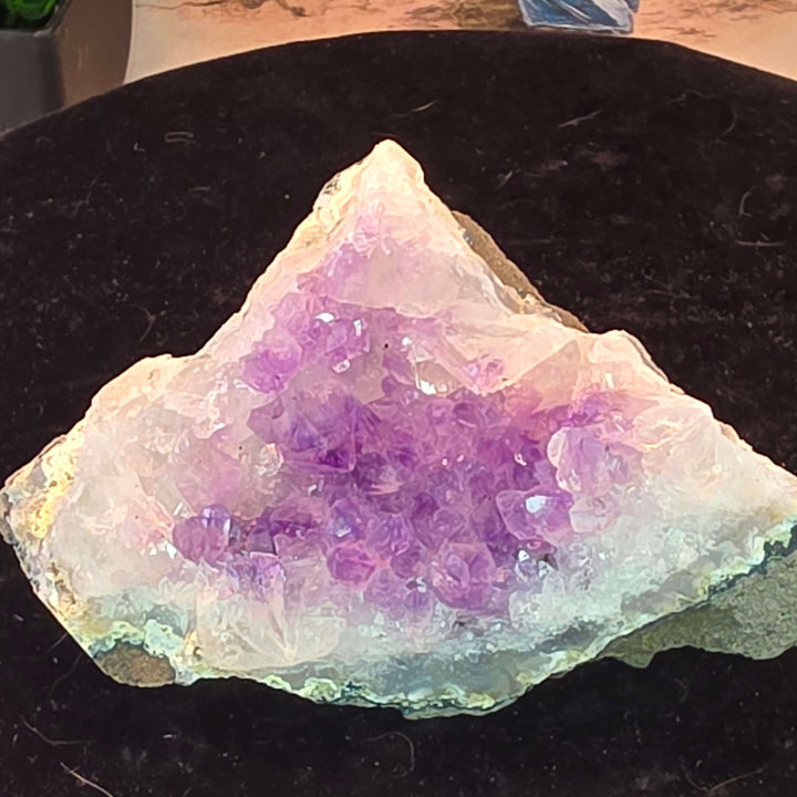 Experience the magic of nature with our exquisite Amethyst Geode Cluster! This stunning piece boasts a captivating array of extremely sparkly, brilliant clear purple crystals that shimmer with every turn. Perfect as a dazzling display piece for your home