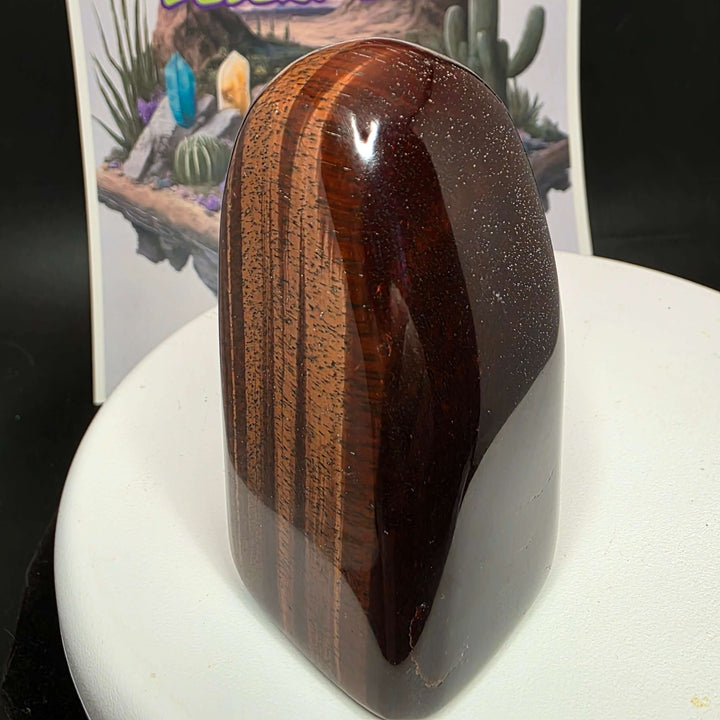 Polished Red Tiger's Eye freeform showcasing distinct reddish-brown colors with natural oxidation and heating effects.