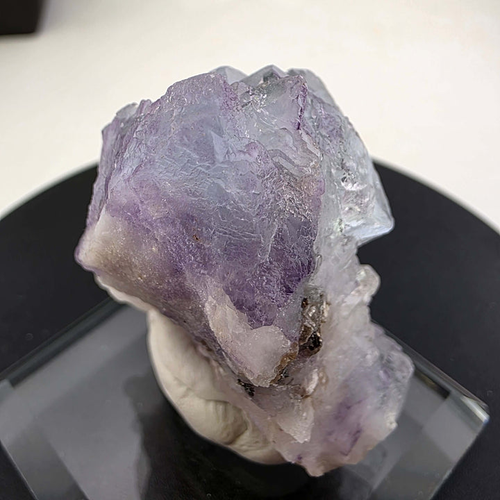 Fluorite Specimen - Yaogangxian Mine China featuring intergrown violet crystals on a display base.