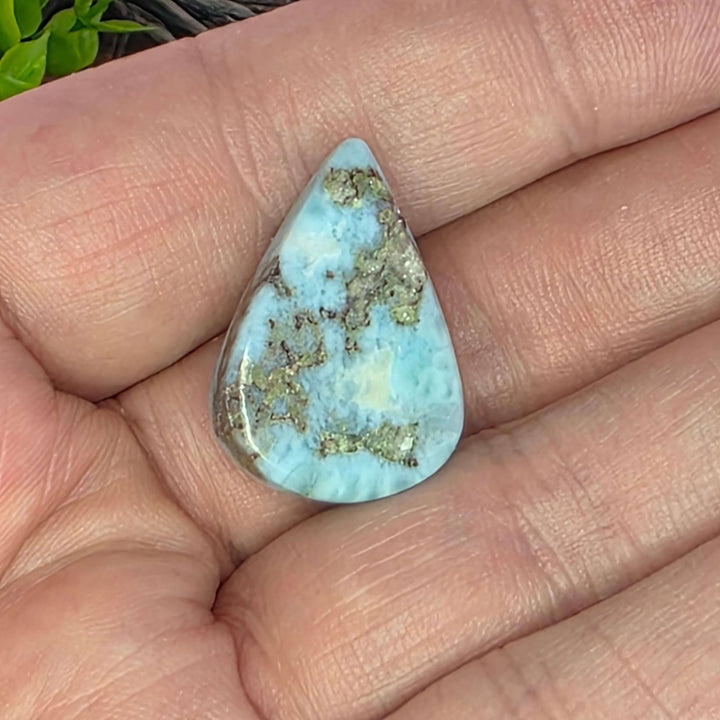 Dive into the tranquil beauty of our Larimar Cabochons. Sourced from the Dominican Republic, these rare and captivating gemstones showcase stunning shades of oceanic blues and whites, reminiscent of Caribbean waters. Each beautifully polished cabochon pai