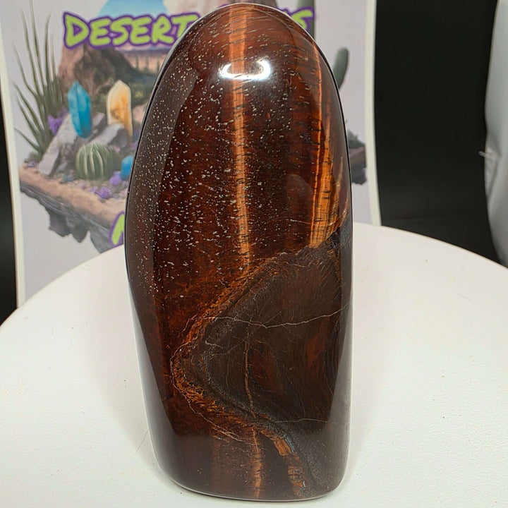 Polished Red Tiger's Eye freeform with reddish-brown colors, showcasing natural beauty and unique patterns.