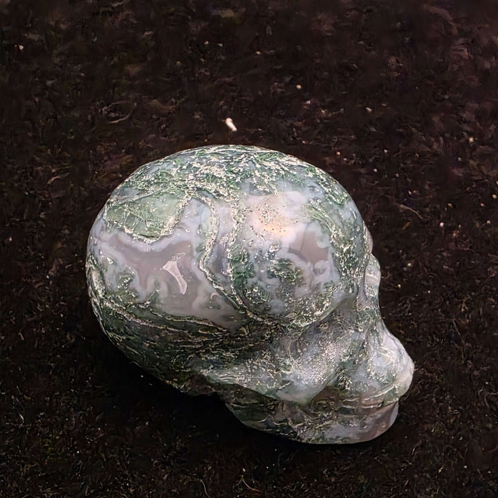 Moss Agate Skull Carving - 2 inch showcasing unique blue-green dendritic inclusions and frosty white matrix.