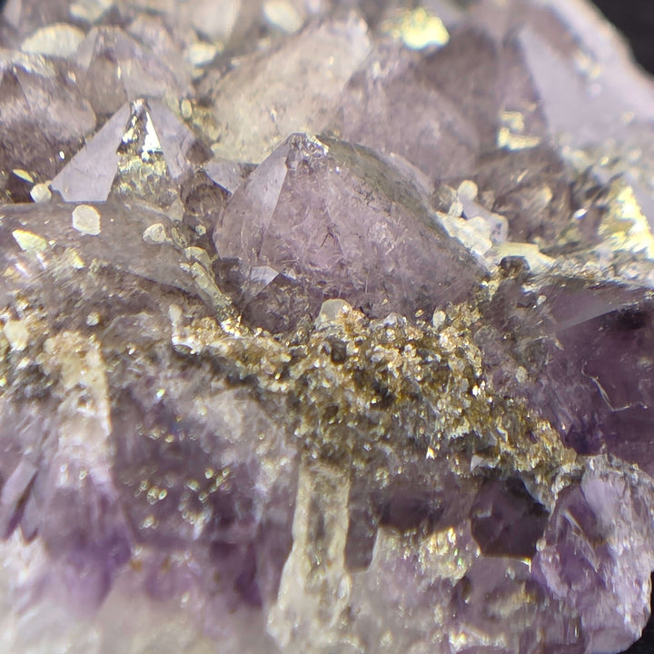 Embrace the raw beauty of nature with this unique Amethyst Geode Cluster. While it carries minor natural inclusions—perhaps hints of earthy hematite or other intriguing minerals—and some gentle signs of its journey, these features only add to its authenti