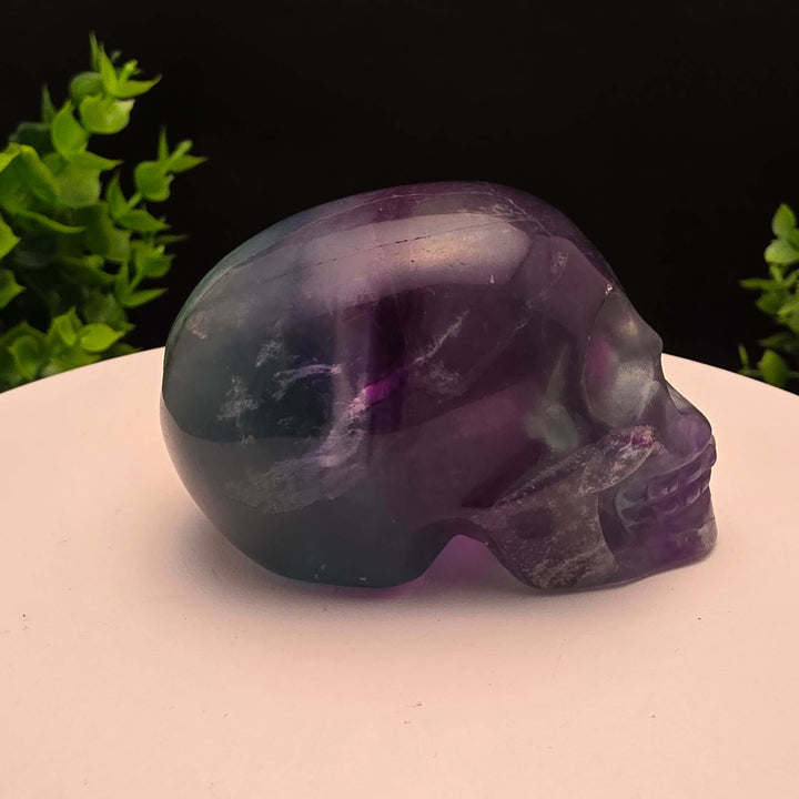 Rainbow Fluorite skull carving - 2.5 Inch; showcasing purple and blue hues, stunning details, and intricate craftsmanship.