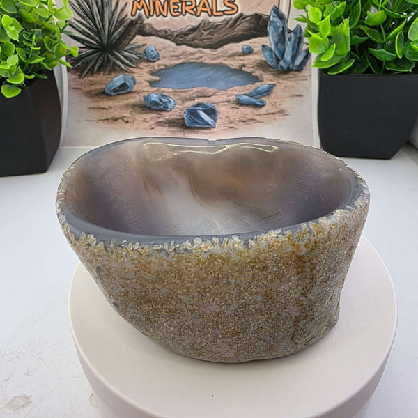 Hand carved Agate Bowl showcasing a smooth interior and rugged exterior, perfect for functional art display.