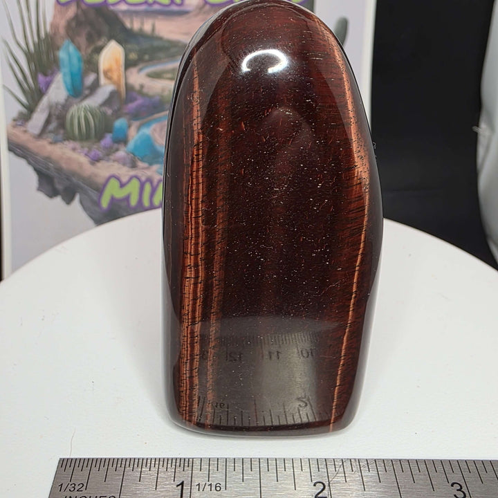 Polished Red Tiger's Eye freeform with reddish-brown hues, showcasing natural oxidation patterns.