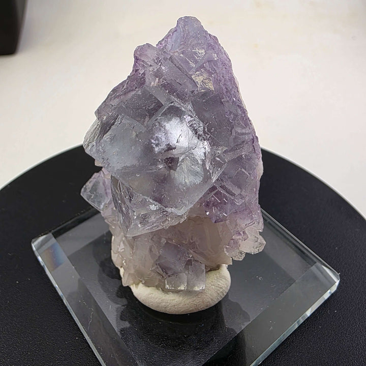 Fluorite Specimen - Yaogangxian Mine China featuring intergrown violet crystals on a display base.