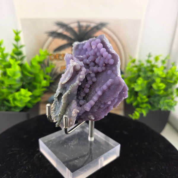 Discover the unique beauty of ‘Grape Agate’, an Amethystine Spherical Quartz found in Indonesia. This gemstone is known for its grape-like clusters and vibrant colors. Stand is included with purchase
