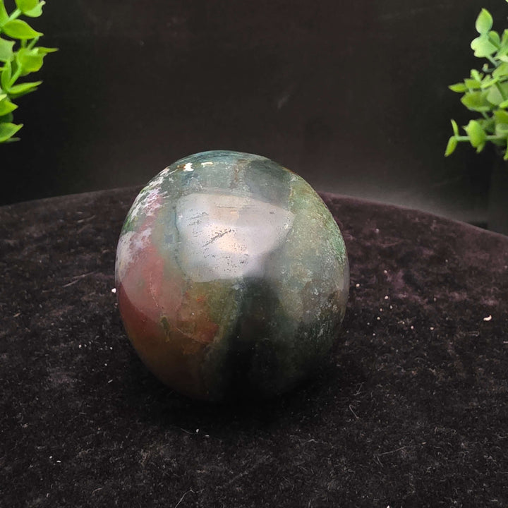  Orbicular Jasper Skull Carving - 2.25 Inch showcasing unique colors and textures on a dark background.