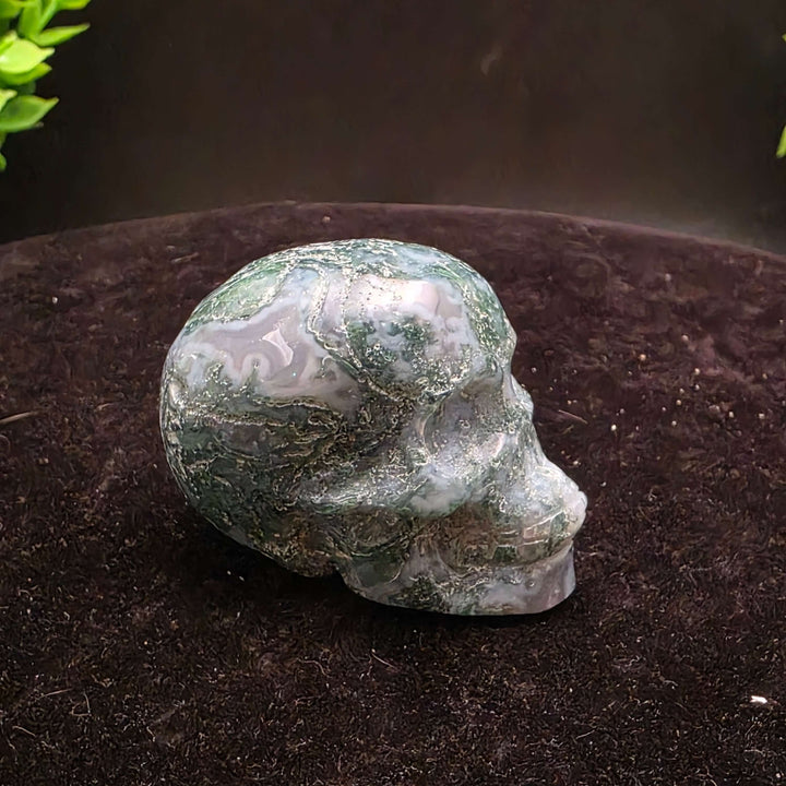 Moss Agate Skull Carving - 2 inch showcasing unique blue-green dendritic inclusions and frosty white matrix.
