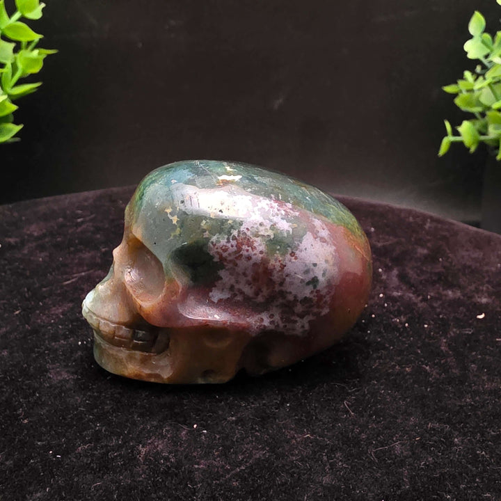  Orbicular Jasper Skull Carving - 2.25 Inch showcasing unique colors and textures on a dark background.
