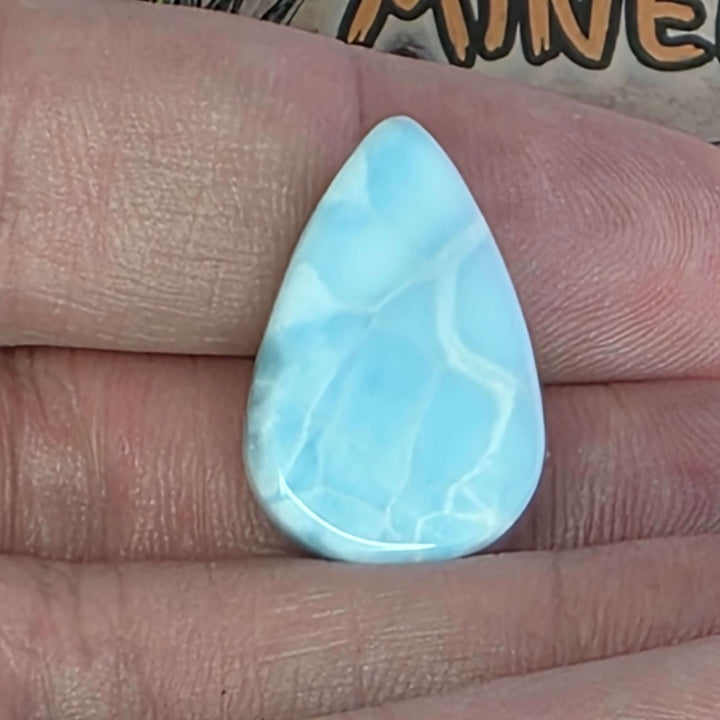 Dive into the tranquil beauty of our Larimar Cabochons. Sourced from the Dominican Republic, these rare and captivating gemstones showcase stunning shades of oceanic blues and whites, reminiscent of Caribbean waters. Each beautifully polished cabochon pai