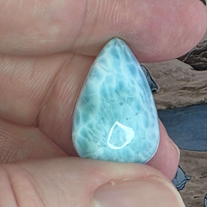 Dive into the tranquil beauty of our Larimar Cabochons. Sourced from the Dominican Republic, these rare and captivating gemstones showcase stunning shades of oceanic blues and whites, reminiscent of Caribbean waters. Each beautifully polished cabochon pai