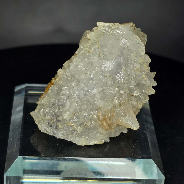 Calcite specimen from Guerrero, Mexico with glass display stand showcasing distinct growth generations.