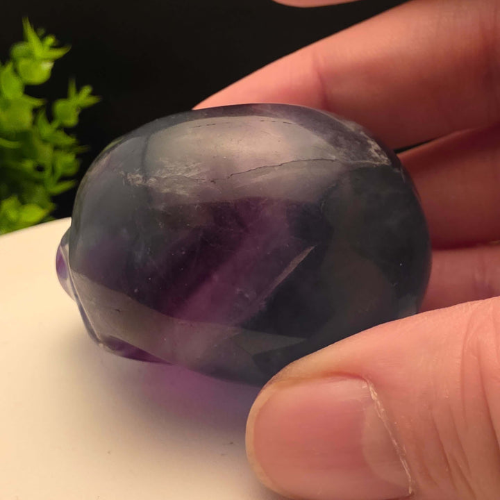 Rainbow Fluorite skull carving - 2.5 Inch; showcasing purple and blue hues, stunning details, and intricate craftsmanship.