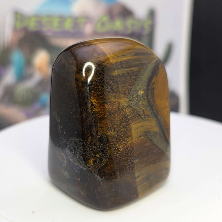 Polished Tiger's Eye freeform showcasing vibrant golden chatoyancy and smooth texture, perfect for crystal collectors.