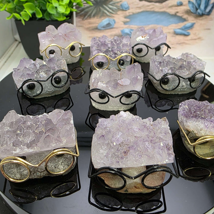 Crystal Buddies - Specimen Carvings featuring cute crystal hedgehogs with glasses on a reflective surface.