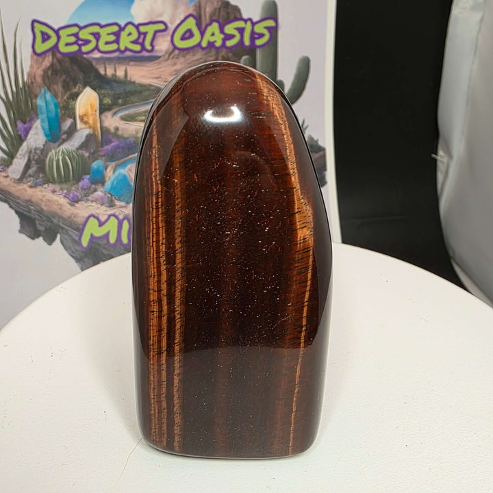 Polished Red Tiger's Eye freeform showcasing distinct reddish-brown colors and unique patterns.